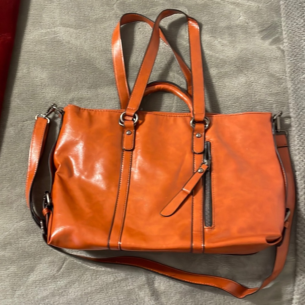 Medium-sized, faux leather, cedar/reddish brown color purse. Brand unknown.